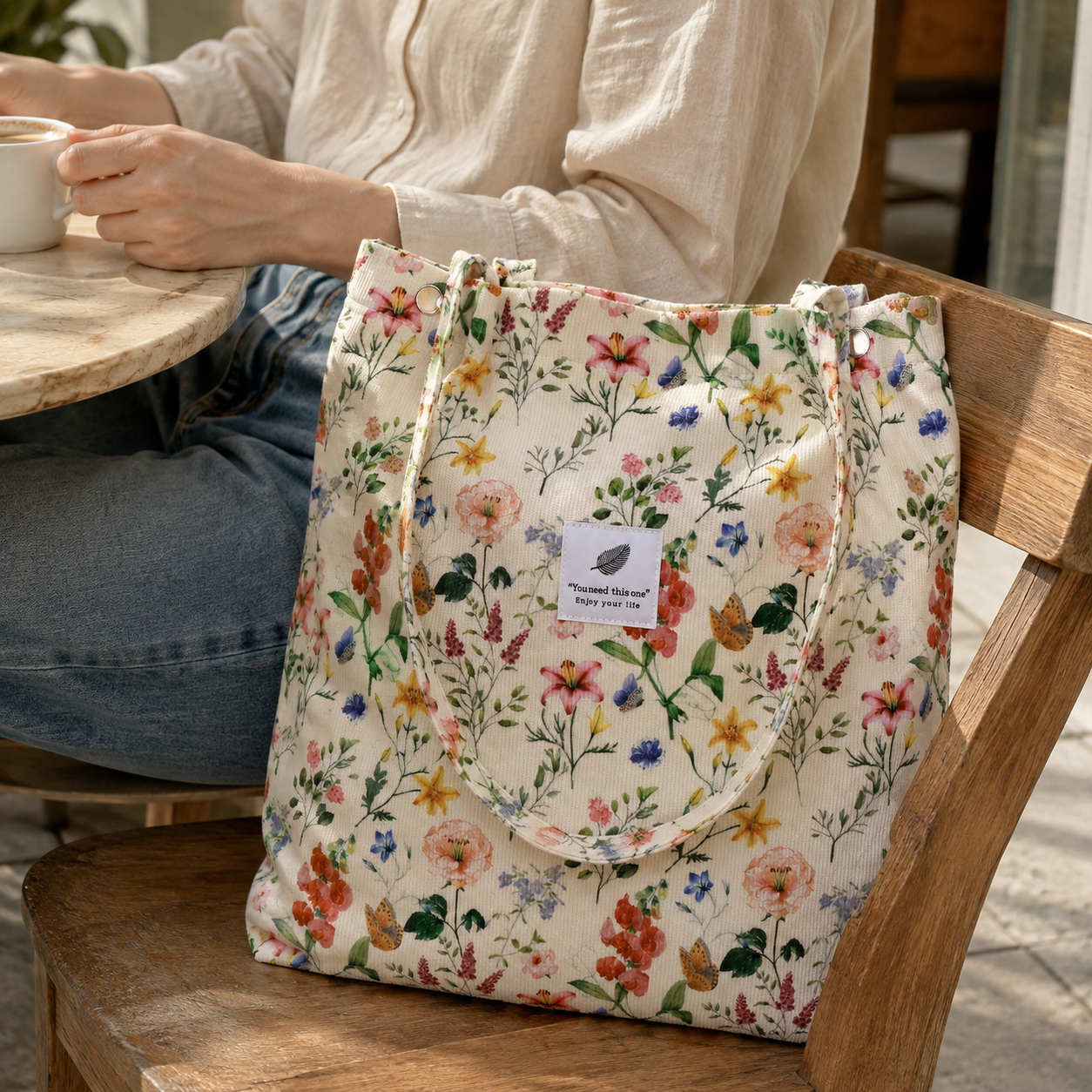 Our Retro Flower corduroy tote styled for a café afternoon; AI styling scene